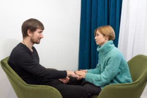 The Female Doctor Psychotherapist Talks With A Depressive Patient In The Office. Health Care Concept Of Professional Psychologist Consultation In Psychotherapeutic Consultation Of Health