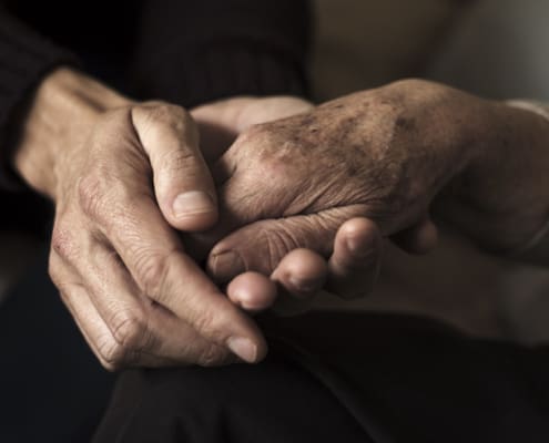 Young Man Holding The Hand Of An Old Woman