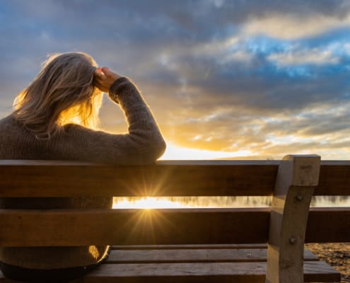 Woman Walking And Resting At The Lake At Sunset