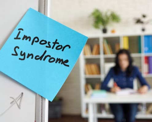 Impostor Syndrome Written On The Sticker On The Whiteboard.