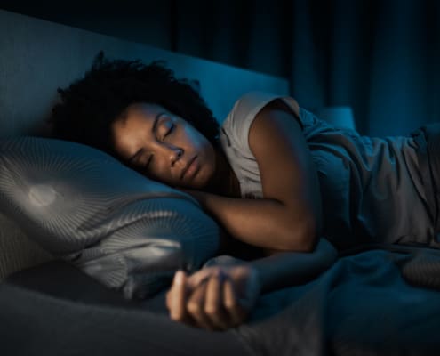 African American Woman Sleeping In Her Bed