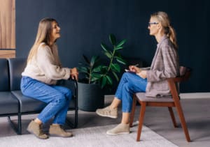 Cheerful Young Woman Patient Has A Casual Conversation With A Consultant Psychologist In The Office.
