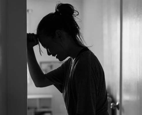 A Sad Woman Crying And Depressed In Her Room At Home Alone.