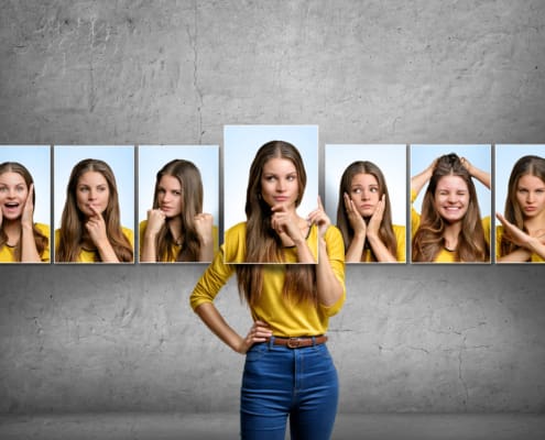 Girl Holds And Changes Her Face Portraits With Different Emotions