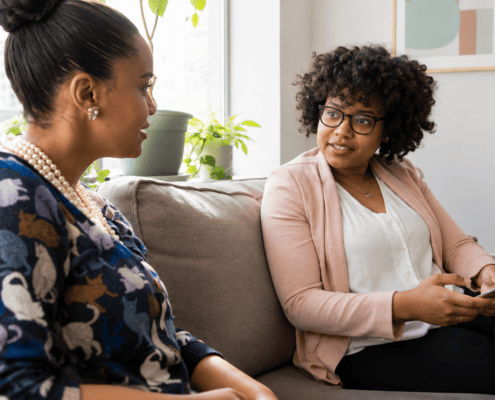 Two women talking together in a counseling office.