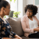 Two women talking together in a counseling office.